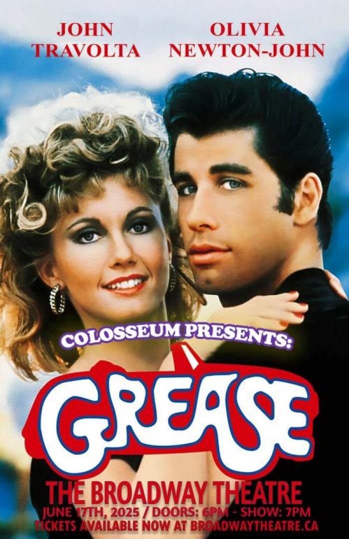Image from the movie Grease with John Travolta and Olivia Newton-John. Shows them hugging while looking at the camera. 