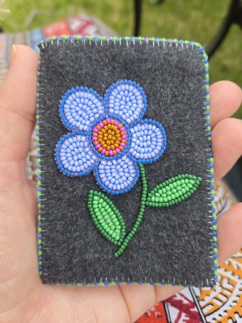 Indigenous beaded card holder featuring blue flower