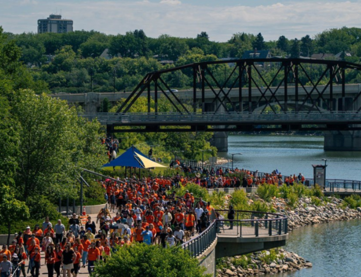 People walking along a river. 