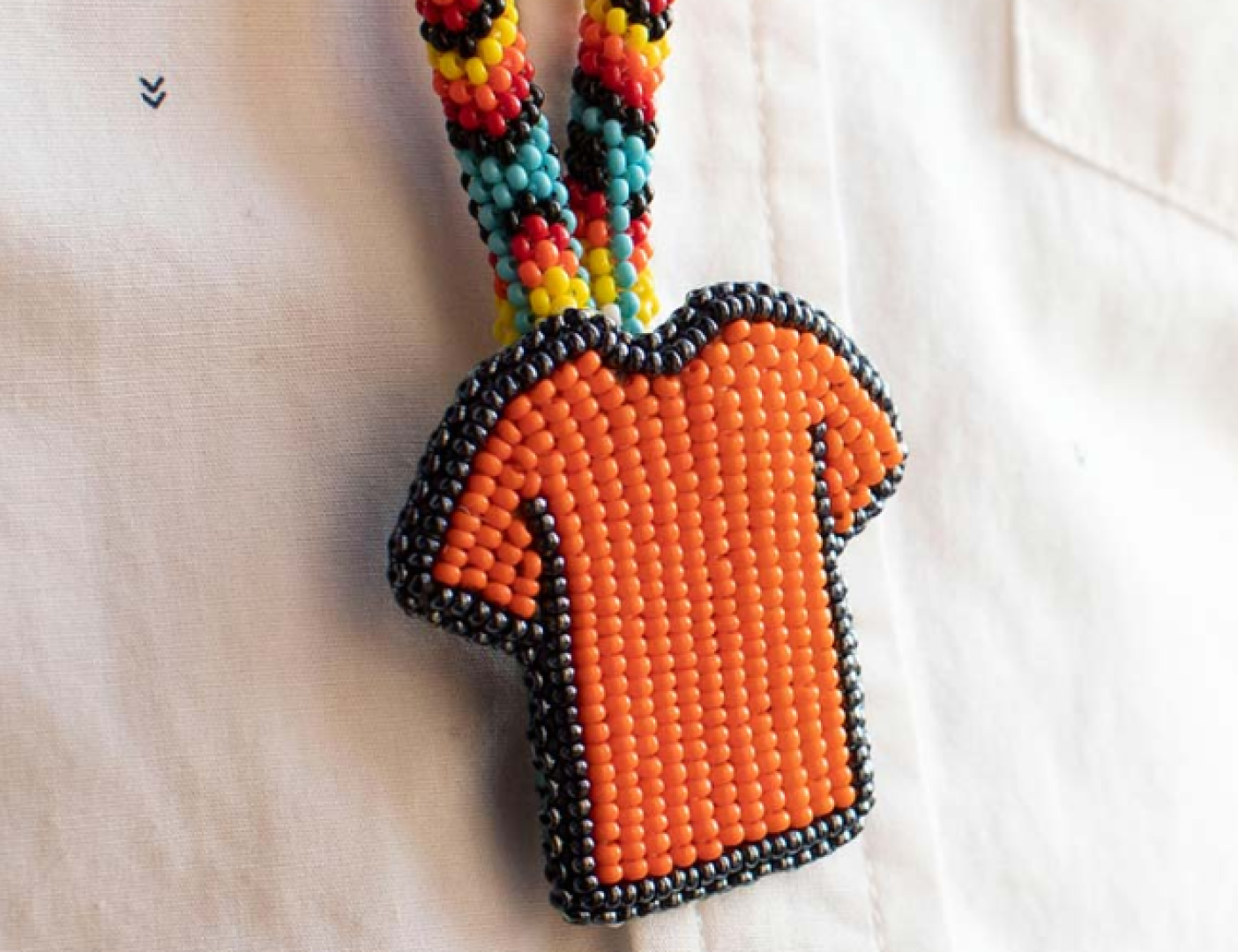Beaded orange shirt.