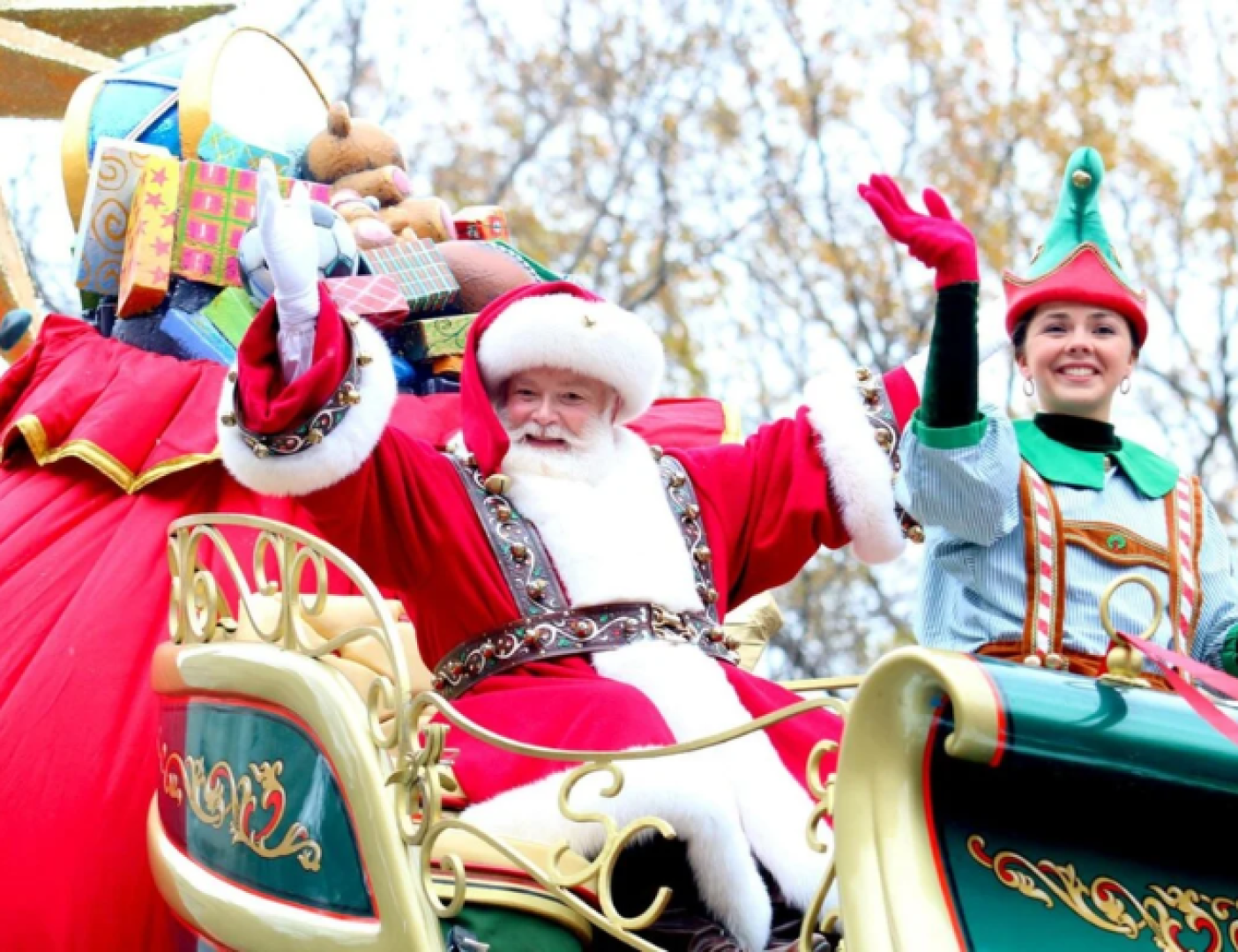 Santa claus parade float with santa and elf.