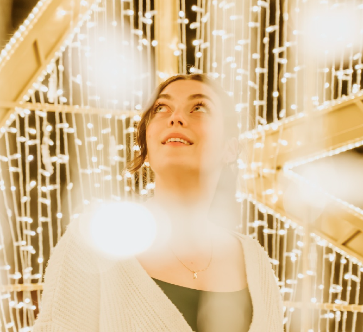 Woman surrounded by glowing lights.