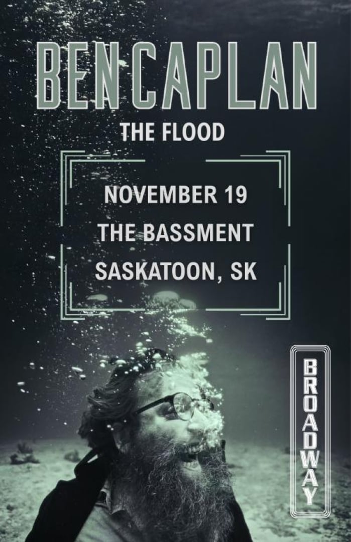 Image of Ben Caplan with his mouth open and bubbles coming out of his mouth slightly obscuring his face. The background is dark with the surface of the water on top and the sea floor on the bottom. A Broadway Theatre logo is on the right. Text is written: Ben Caplan The Flood November 19 The Bassment Saskatoon, SK