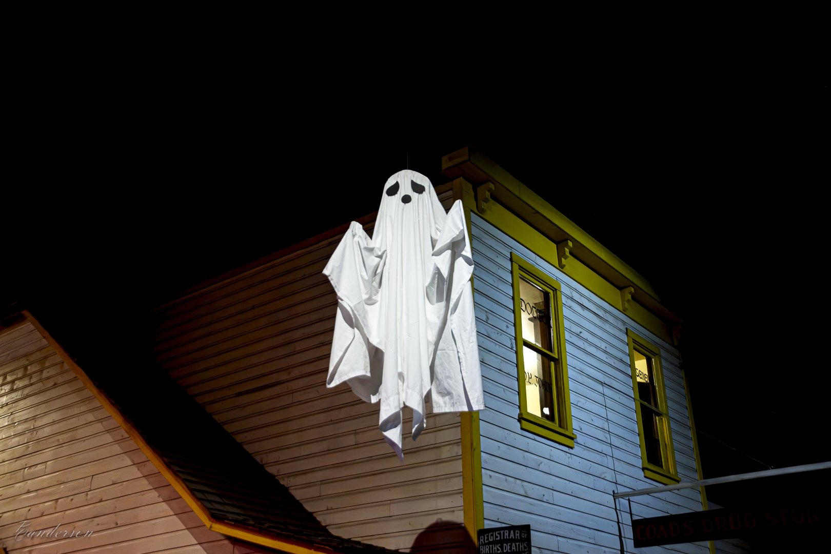 A ghost floating with a building in the background