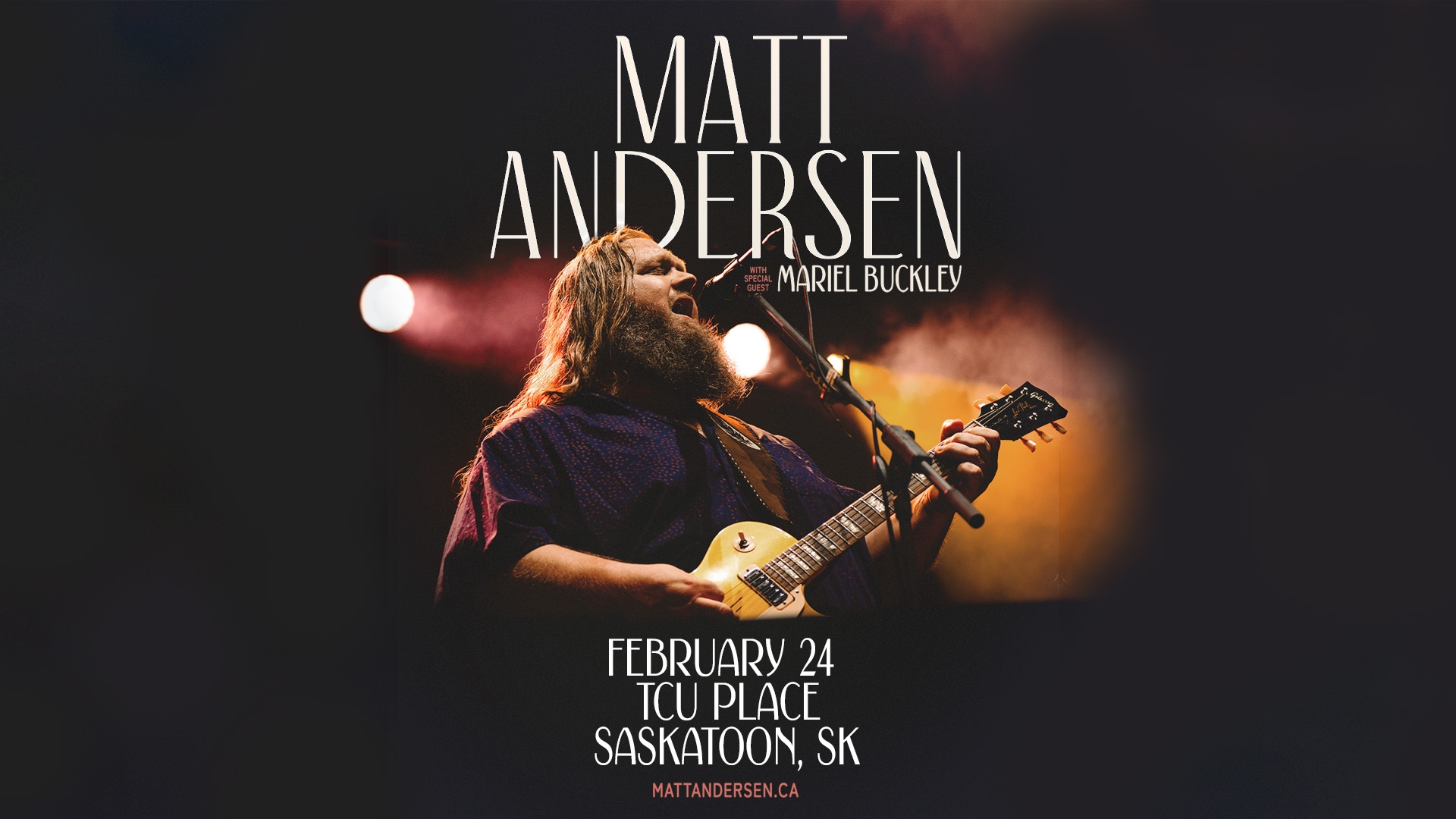 An image of a man singing into a microphone and playing a guitar, with spotlights shining on him. 