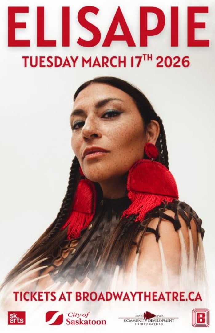 Image of singer Elisapie standing there, with a neautral face.