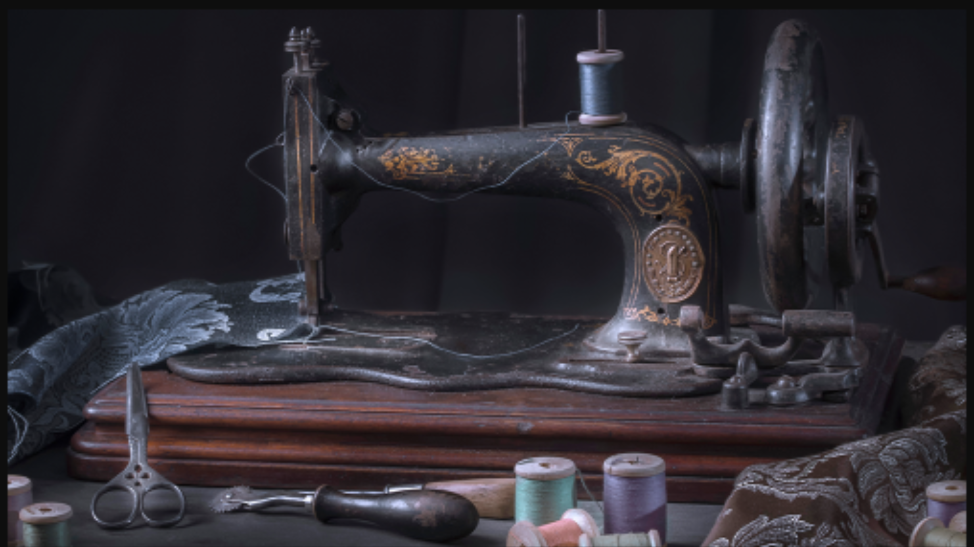 vintage sewing machine sitting on a table with thread and scraps of cloths