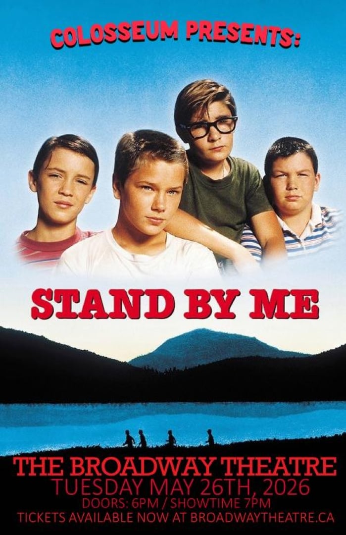 Image of four young boys and a lake with a mountain behind it. 