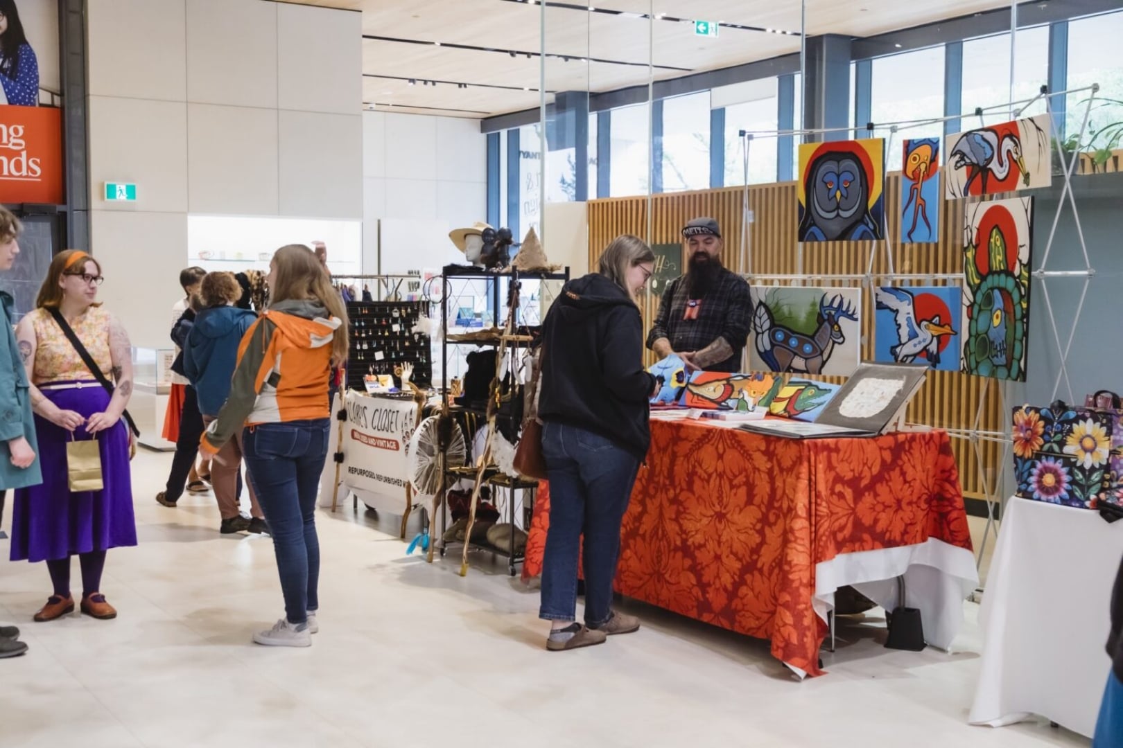 A photo of last year's Metis Market featuring shoppers browsing booths in the atrium of Remai Modern.