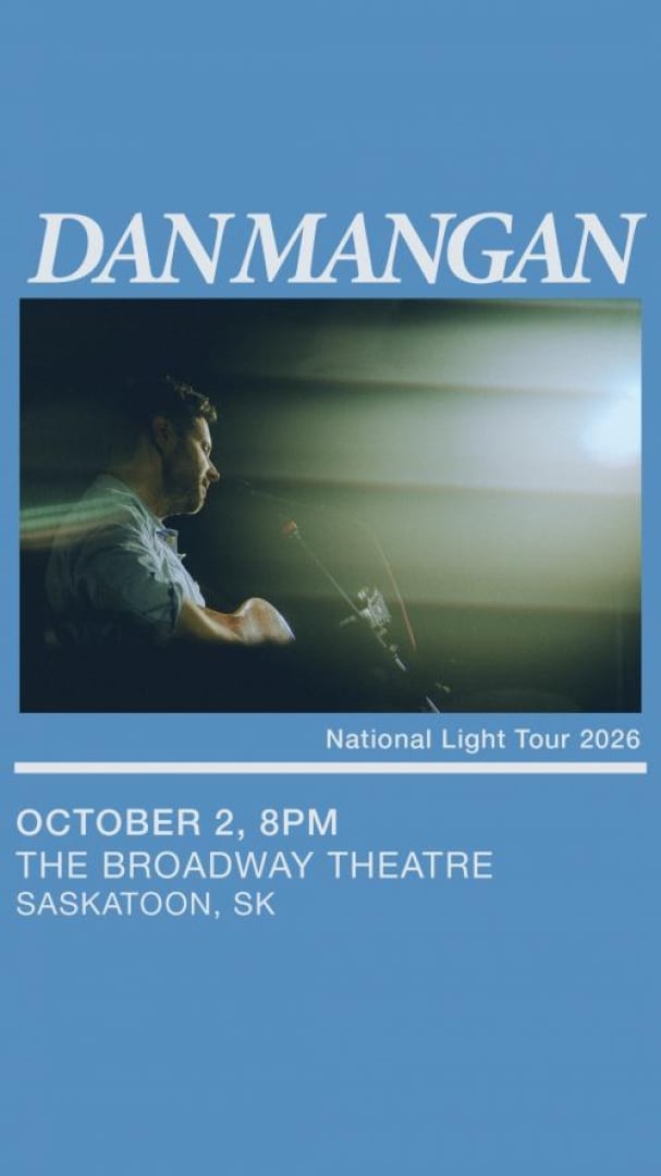 Photo of Dan Mangan's side profile posing while playing with the lights blinding the audience outlook.