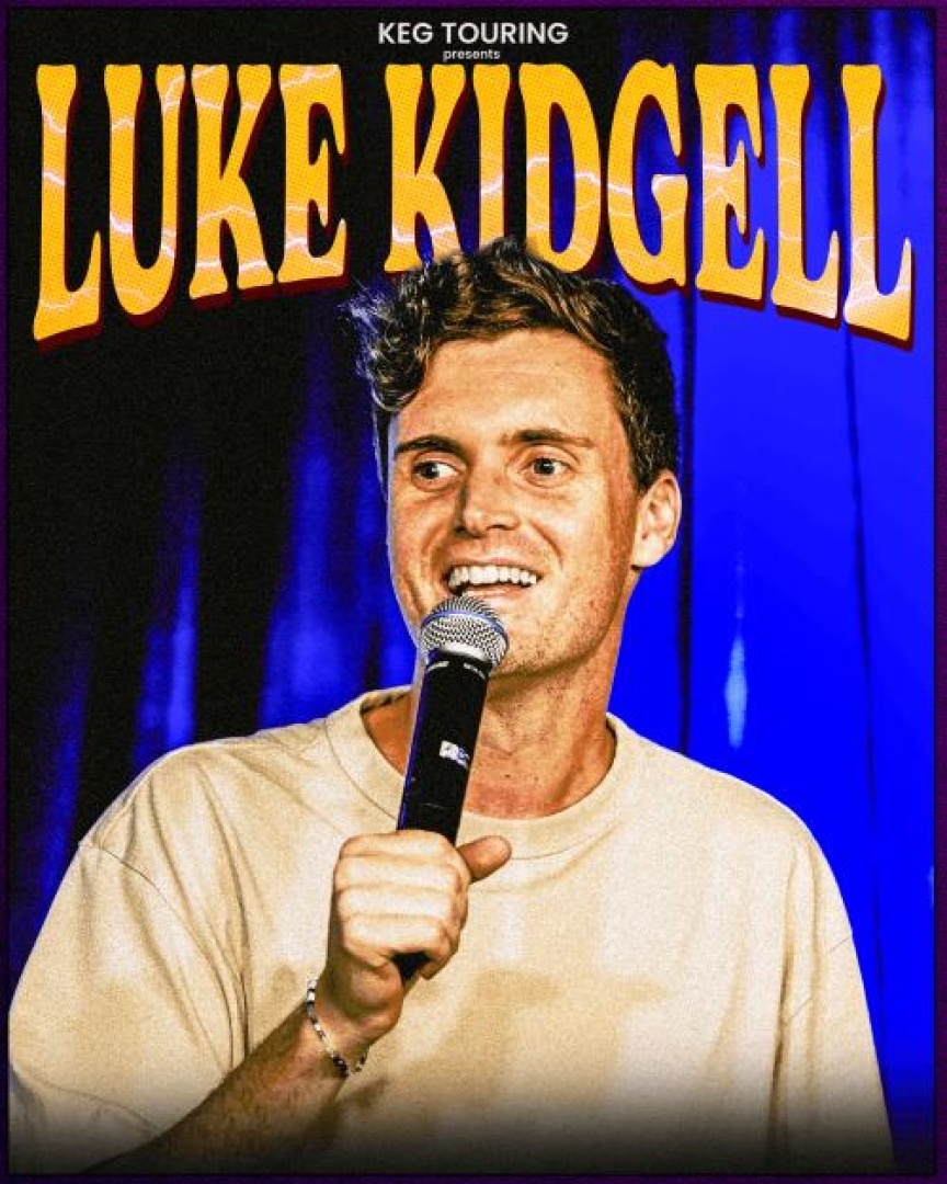 Image of comedian Luke Kidgell holding a mic and looking off into the audience. 