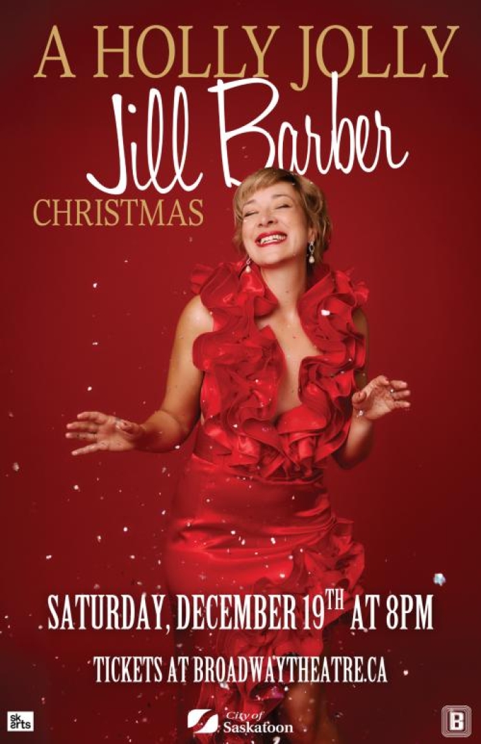 Image of singer Jill Barber in a red dress, smiling with eyes closed as snow is falling down.