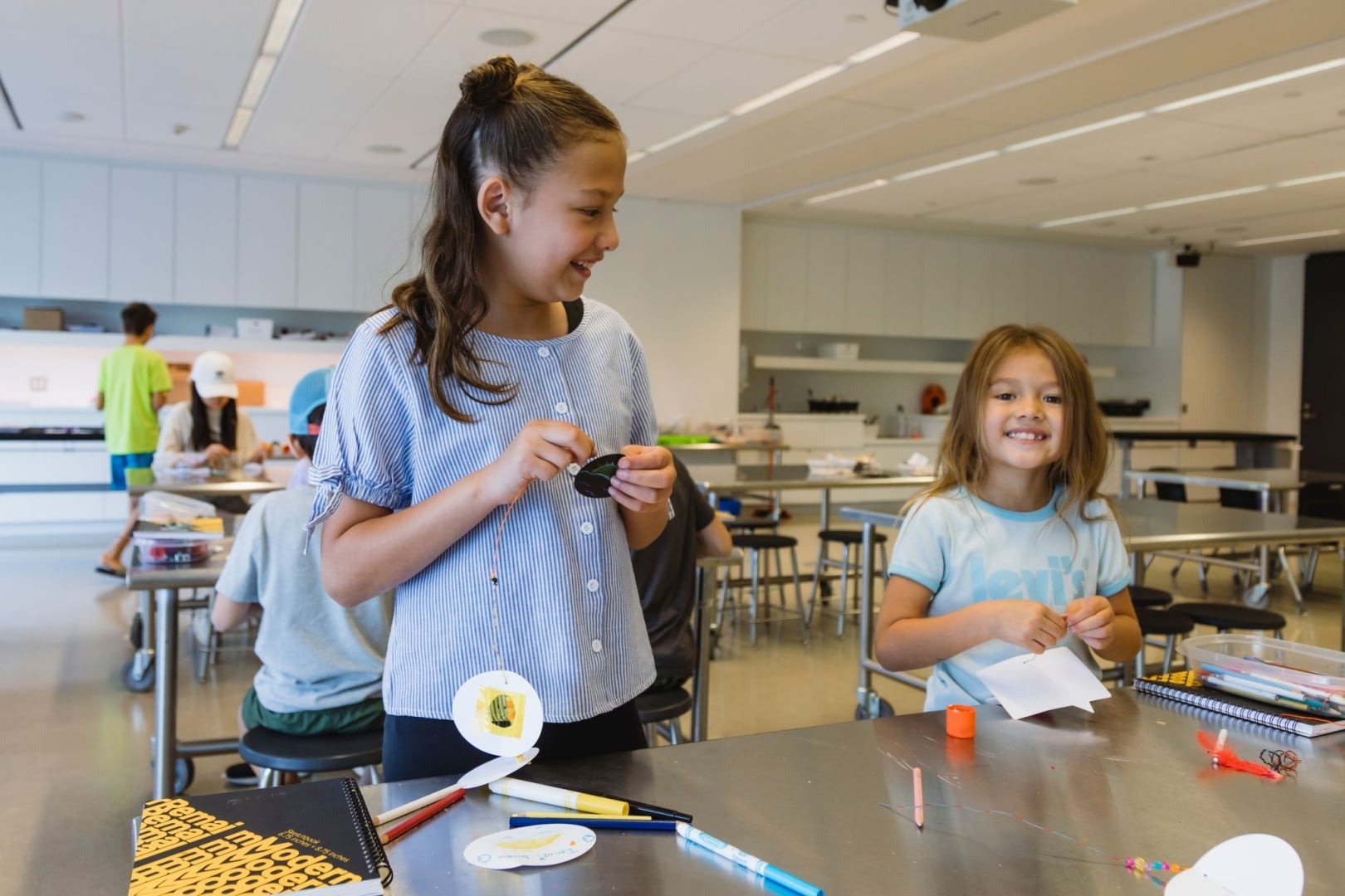 Two children enjoying an afternoon of art making in the Remai Modern learning studio.