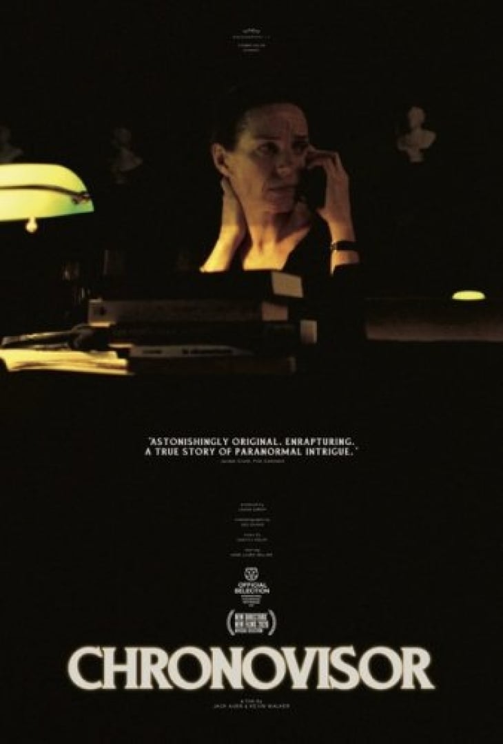 Image of a woman looking off to the side, holding a phone up to her ear and sitting in a dark library. 