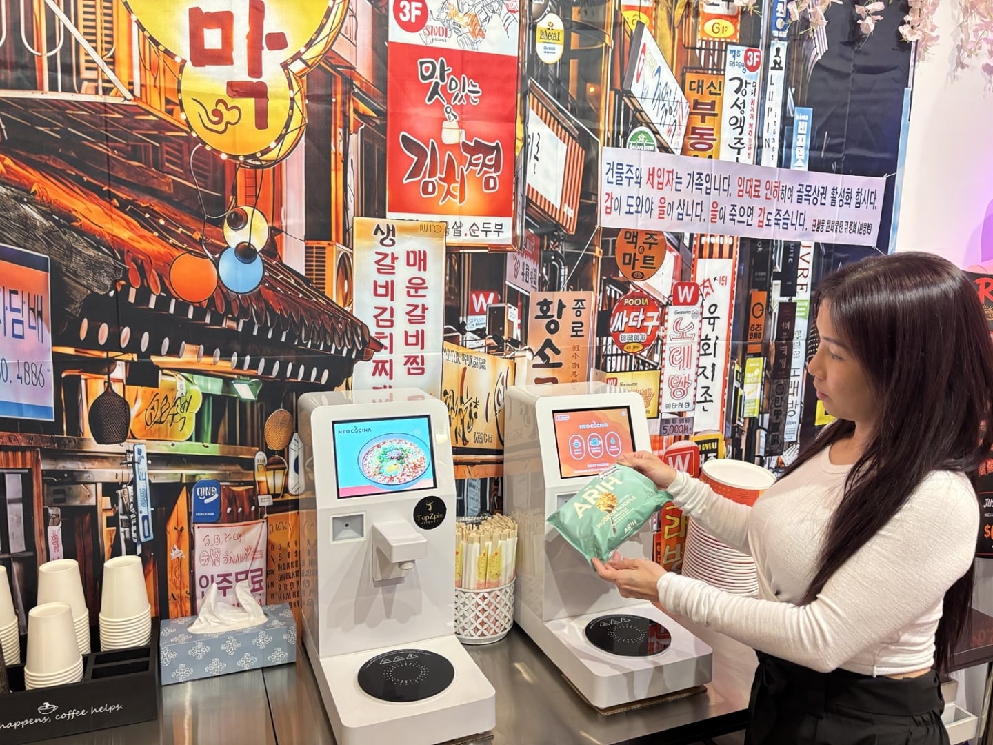 Young Lady scanning a bag of ramen on a ramen machine