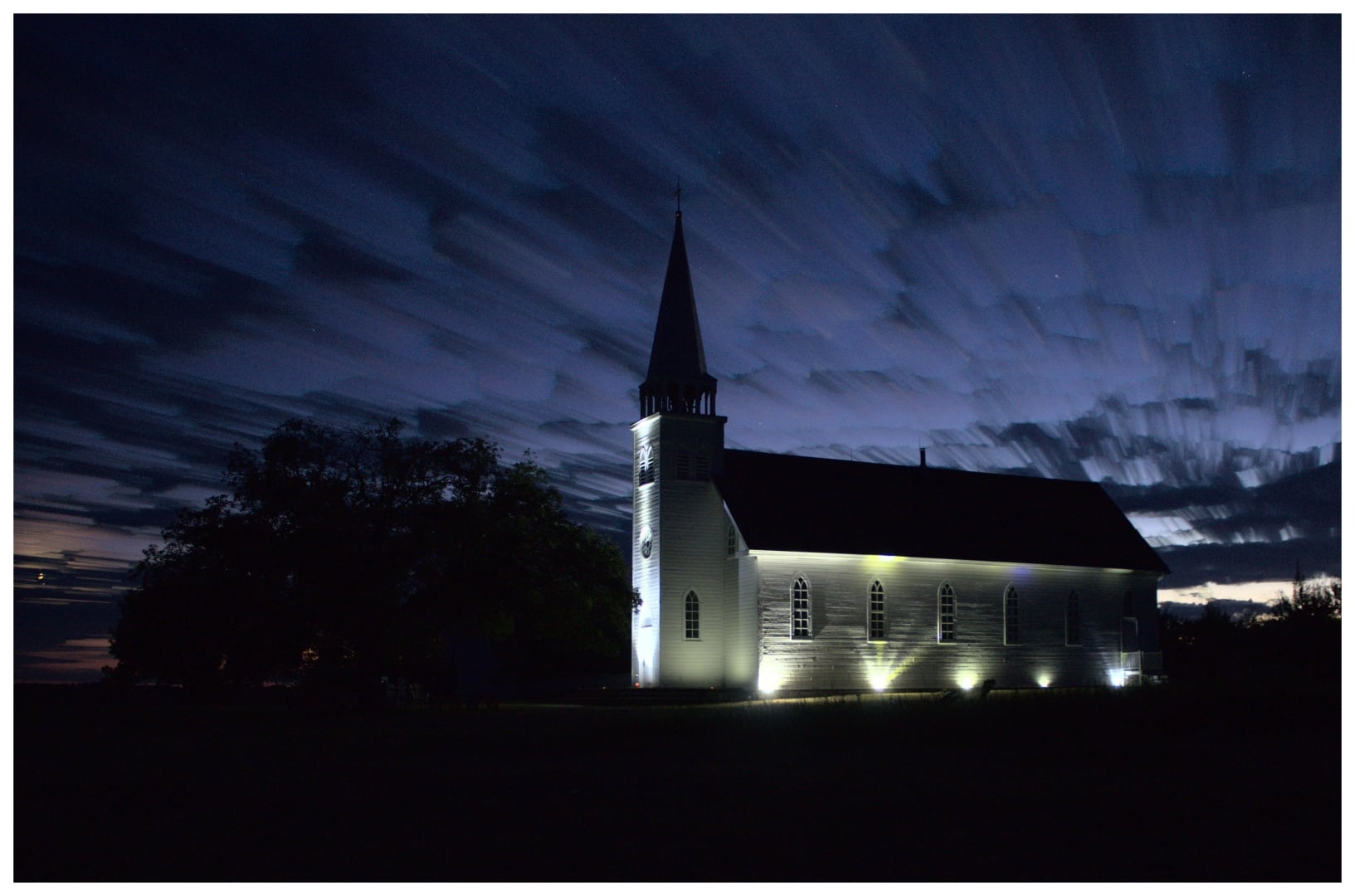 Lights illuminating the historic church at Batoche National Historic Site. 