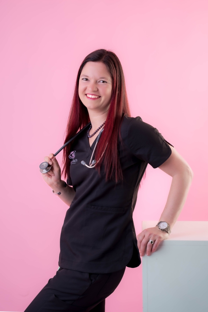 Nurse Nancy looking into the camera with her stethoscope. Pink background.