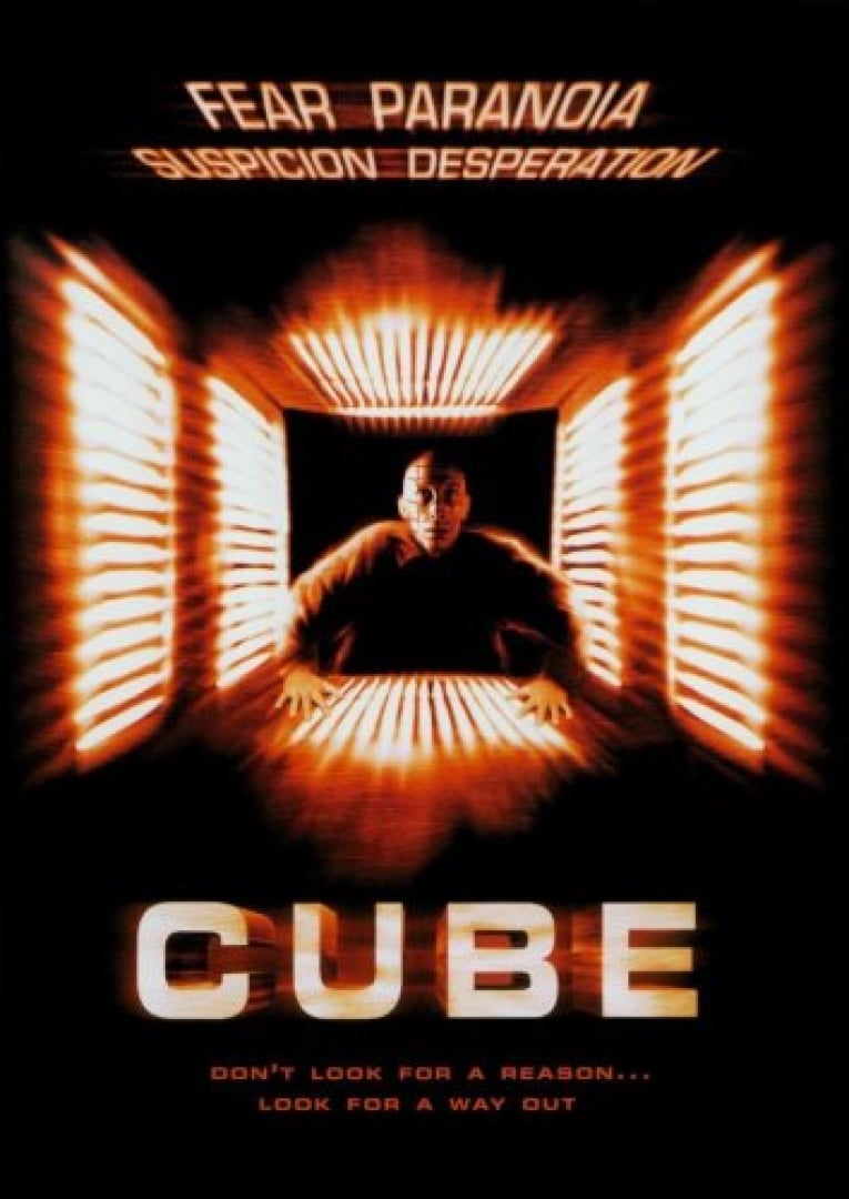 Image of a man in a jumpsuit entering a small square entryway, light up with very bright lights.