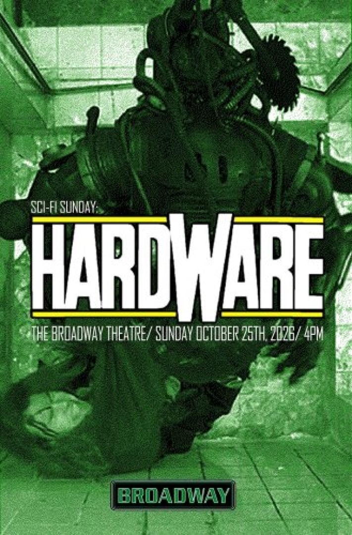 Image of someone covered in mechanical 'junk' in a green tinted still from the movie.